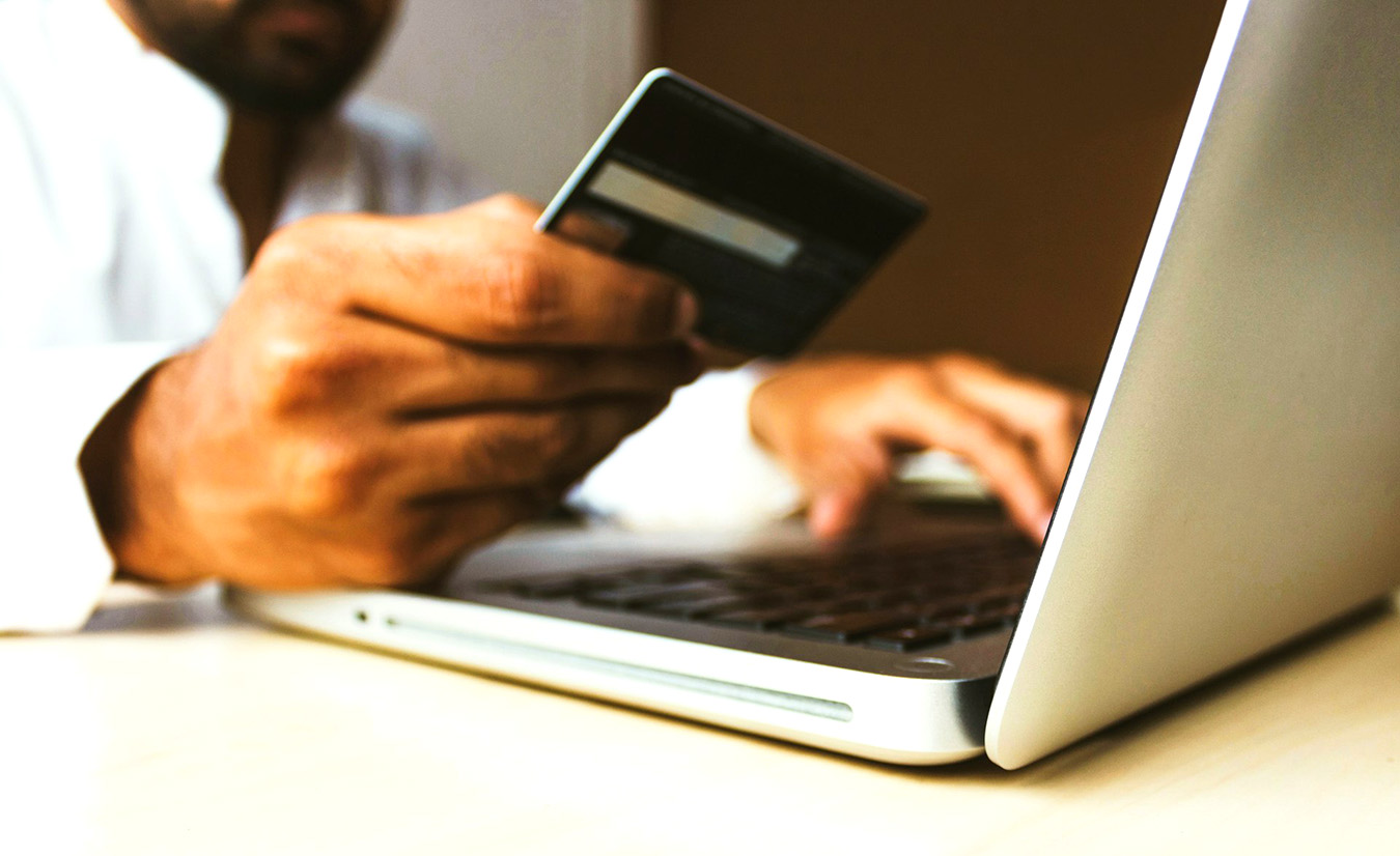 A citizen entering debit card information into a computer